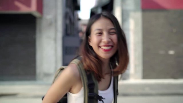 Cheerful beautiful young Asian backpacker woman feeling happy smiling to camera while traveling at Chinatown in Beijing, China. Lifestyle backpack tourist travel holiday concept.