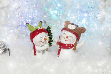 Two funny snowmen in the Christmas decorations