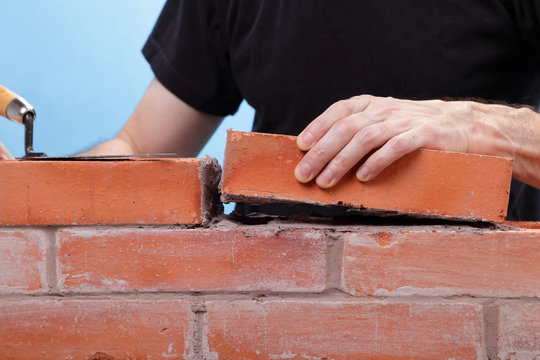 Man Building A Brick Wall