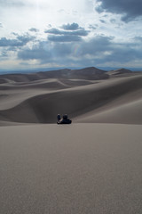 Person relaxing in the sand dunes - 228754952
