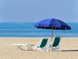 umbrella with deck chairs and sun lounger on the  beach