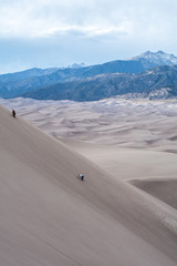 Climbing sand dunes in the mountains - 228757701