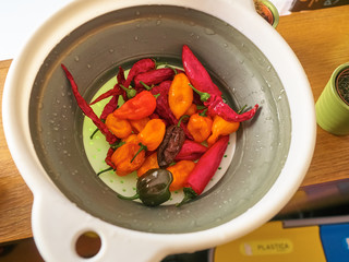 Shot of a mix of red, orange, yellow and balck peppers