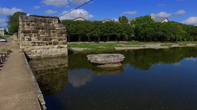 The Brushy Creek Crossing at The Round Rock, for years this creek bed was the low water crossing near town.  To this day the limestone bottom has ruts from the wagon wheels cut into it.