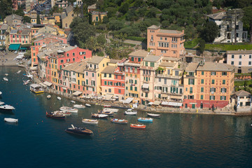 Fototapeta na wymiar Portofino luxury landmark panorama. Village and yacht in little bay harbor. Liguria, Italy