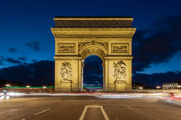 Fototapeta na wymiar L'Arc de Triomphe by night with car light trails