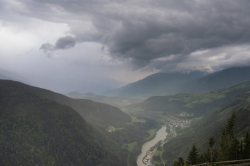 Obraz premium Wide angle panorama photo of Dolomites mountains, Italy. Summer hiking in Dolomites, north Italy. Picture of mountain peaks, nice valley and highlands in sunny weather with blue sky and clouds
