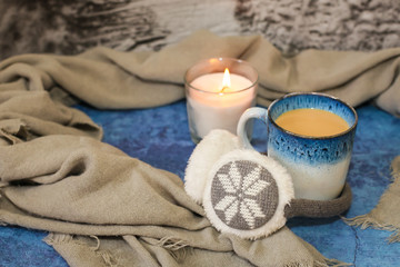 Obraz na płótnie Canvas Autumn and winter background with candle, scarf, mug of cocoa, coffee or hot chocolate. Concept of warm cozy home