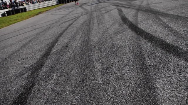 Drift marks on an asphalt from drift tires, slow motion fly by