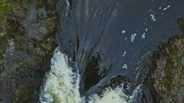 Aerial footage of a Karelian waterfall Kivach, full water stream over the top, beautiful nature, foam on water