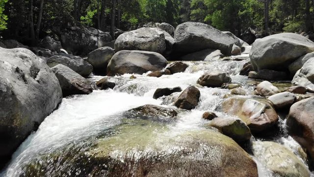 Low Drone Footage Flying up a River in the Mountains of Corsica, France