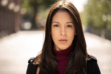 Young woman in city serious face portrait