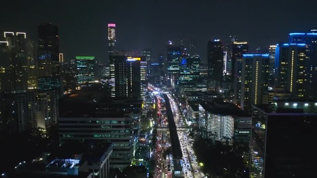 JAKARTA, Indonesia - October 15, 2018: Beautiful aerial scenery of Jakarta skyline with night traffic view and modern buildings. Shot in 4k resolution