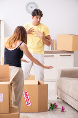 Young couple moving to new flat with fragile things