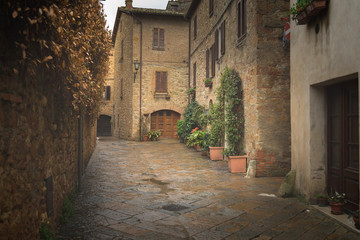 Fototapeta na wymiar Flowery streets on a rainy spring day in a small magical village Pienza, Tuscany