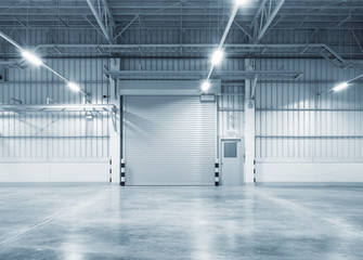 Roller door or roller shutter inside factory, warehouse or industrial building. Modern interior...