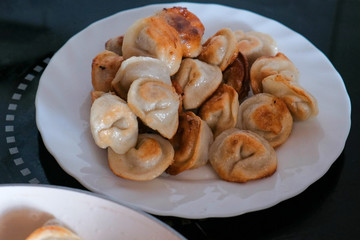 Fried dumplings on a plate on table.