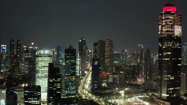 JAKARTA, Indonesia - October 16, 2018: Aerial view of Jakarta city with skyscrapers and beautiful night lights at night. Shot in 4k resolution