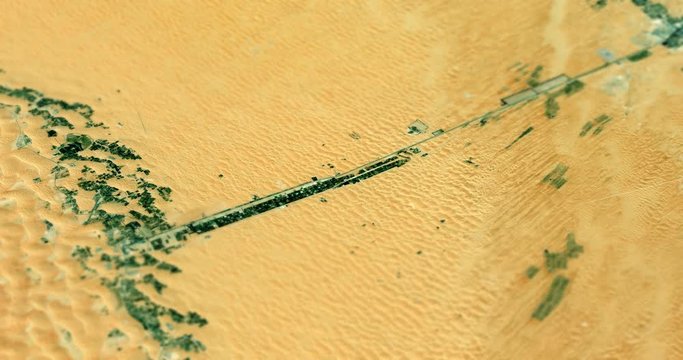 Very high-altitude circular tracking shot of Liwa Oasis, Abu Dhabi, UAE with tilt-shift effect. Reversible. Elements of this image furnished by NASA. 