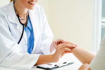 Woman Doctor and Female Patient in Hospital Office