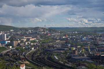 The urban landscape of the Murmansk Soviet architecture and the bright foliage of summer.