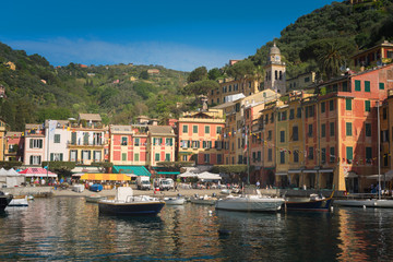 The beautiful Portofino panorama with colorfull houses, luxury boats and yacht in little bay harbor. Liguria, Italy