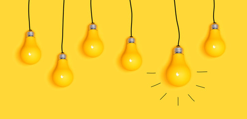 Many hanging light bulbs on a yellow background