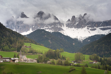 Colors of Dolomites. funes view of the valley, Puez-Odle in autumn. at sunset holy magdalena. View of odle mountain