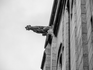 Looking up at a Stone Gargole On the Side of Church