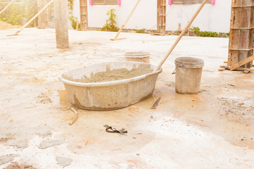mortar in black plastic bucket cement mixer in workplace construction with copy space add text