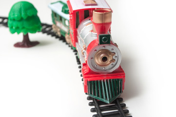 closeup of miniature plastic train on white background