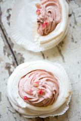 Meringue nests with pomegranate cream topped with pomegranate seeds