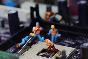 Selective focus of miniature engineer and worker fixed and repair CPU processor,  mainboard...