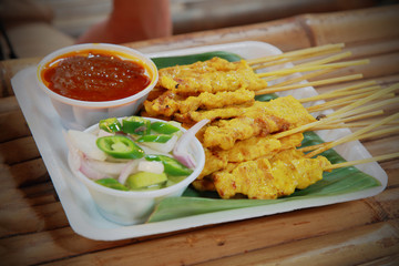 chicken satay, sate ayam and lontong with peanut sauce, Thailand food.