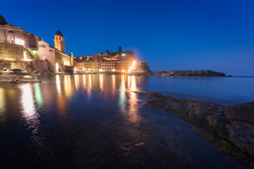 Panorama of night fishing village Vernazza with Santa Margherita di Antiochia Church and lookout...
