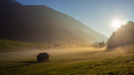 Fototapeta premium Fall sunrise on the alps with moisture in the air