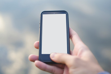 Man's hands holding smart phone with white copy space screen, Shadow of the sky screen.