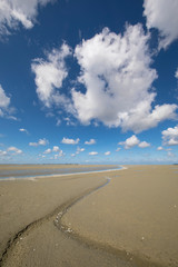 Litlle river flowing on the beach into sea, Somme Bay, Picardy, France.