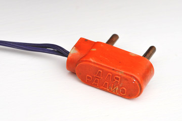 Vintage orange bakelite two pin plug with inscription 