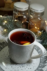 Decorative cookies in the shape of a Christmas tree and snowman and mulled wine with spices
