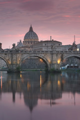 Fototapeta premium Vatican City, Rome, Italy, Beautiful Vibrant Night image Panorama of St. Peter's Basilica, Ponte St. Angelo and Tiber River at Dusk in Summer. Reflection of The Papal Basilica of St. Peter
