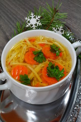 Hot traditional chicken soup in a white dish ,served at Christmas dinner
