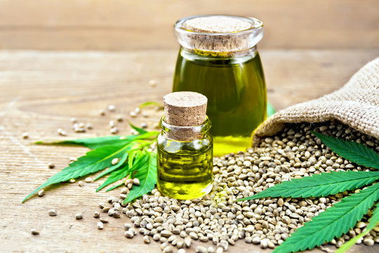 Oil hemp in two jars with grain on board