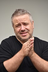 Fototapeta premium Pleading Unshaven Caucasian Male