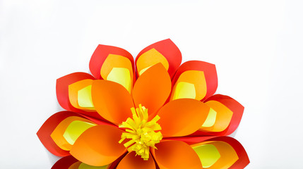 A large flower made of paper orange-red yellow colors