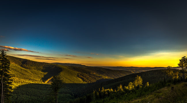 Yellow sunset and dark blue sky on path from Serak to Ramzova, scenic view on valleys in Jeseniky, Czech Republic