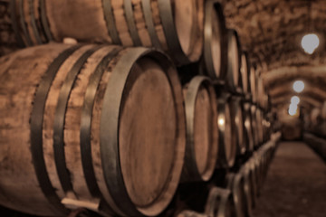Large wooden barrels in wine cellar, closeup
