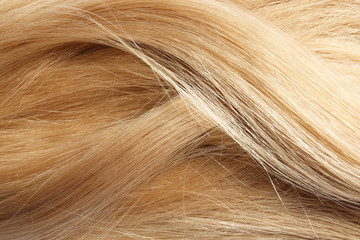 Texture of healthy blond hair as background, closeup
