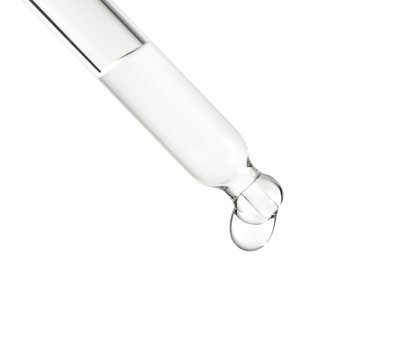 Pipette with essential oil on white background