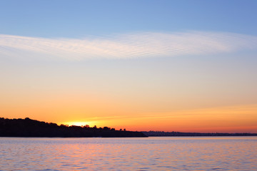 Fototapeta na wymiar Picturesque view of beautiful sunset on riverside